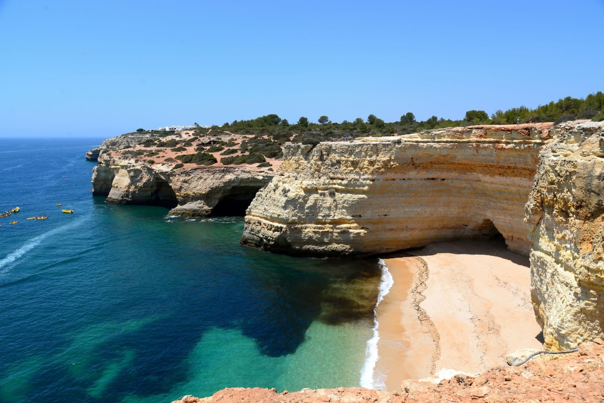 Golden limestone cliffs and a hidden sandy cove on the Algarve coast