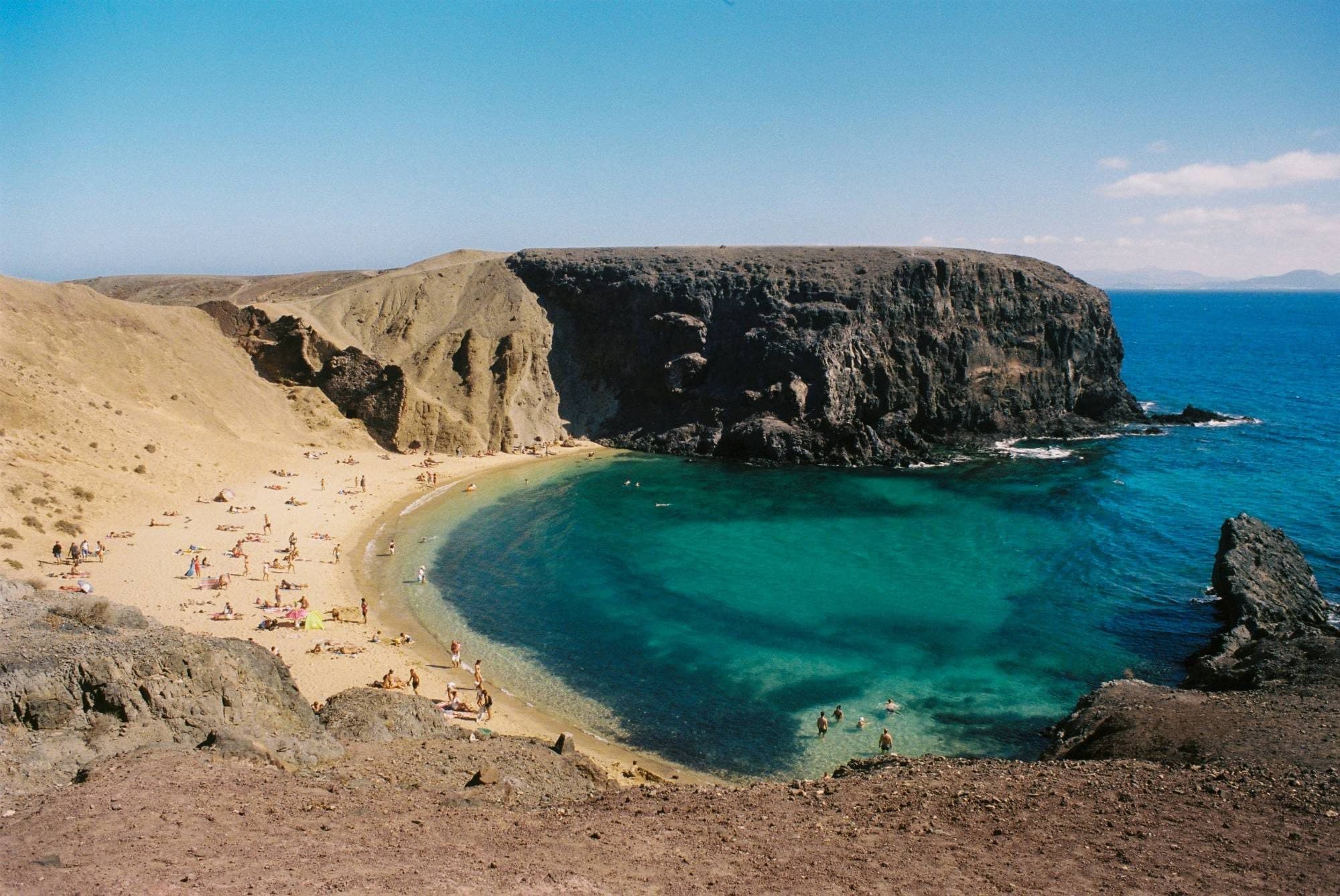 Papagayo beach, a sheltered golden cove below dark volcanic cliffs in Lanzarote